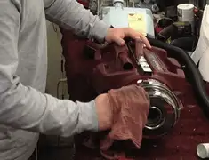 Vacuum repair technician cleaning and servicing a vacuum motor in Dover, DE